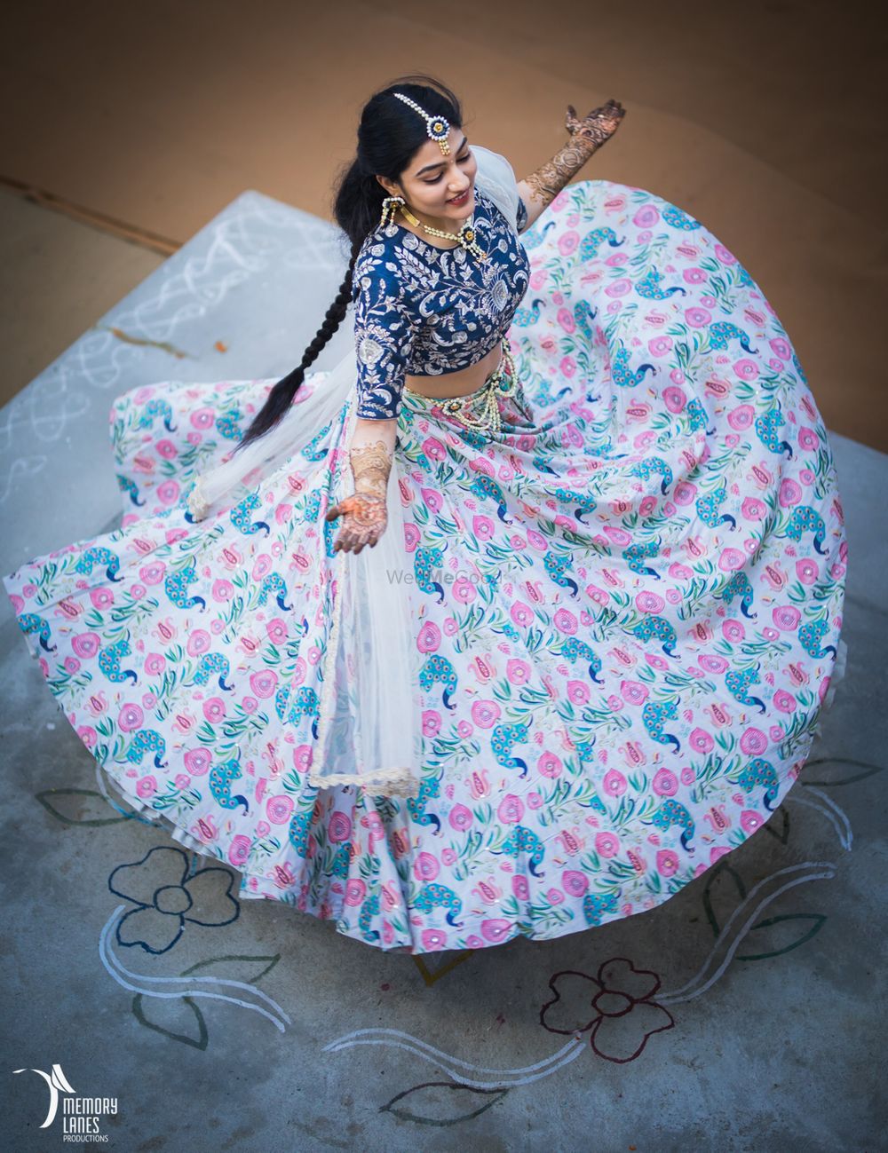 Photo of Bride twirling in offbeat white and blue floral print lehenga