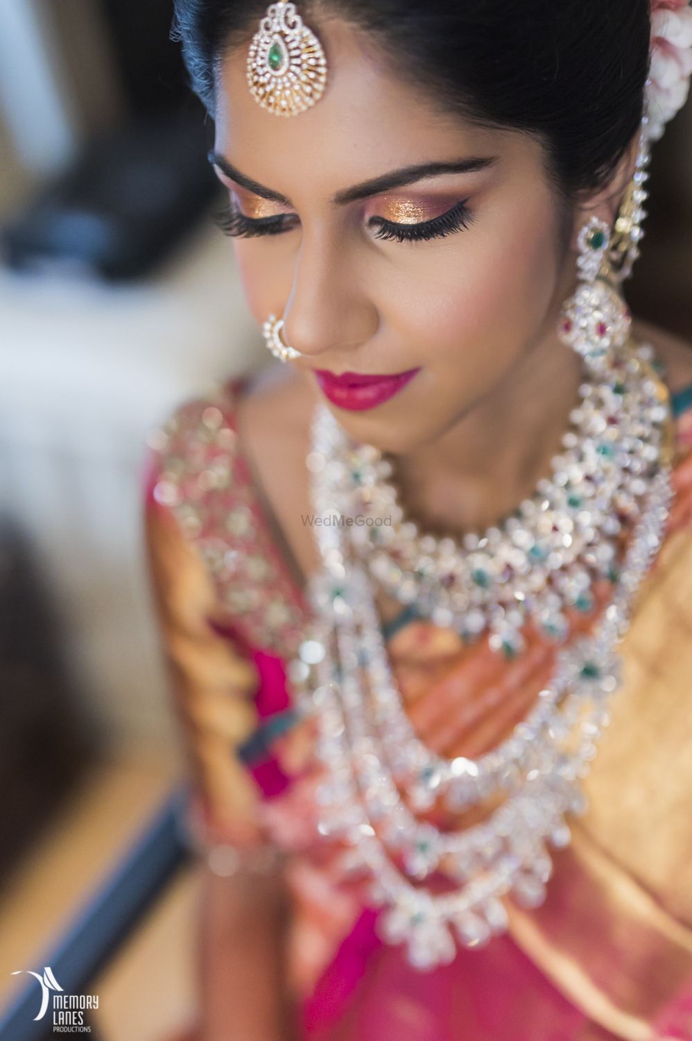 Photo of South Indian bride with gold eyes and emerald and diamond jewellery