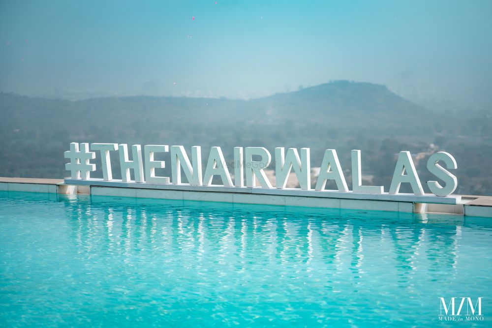 Photo of giant wedding hashtag idea by the pool