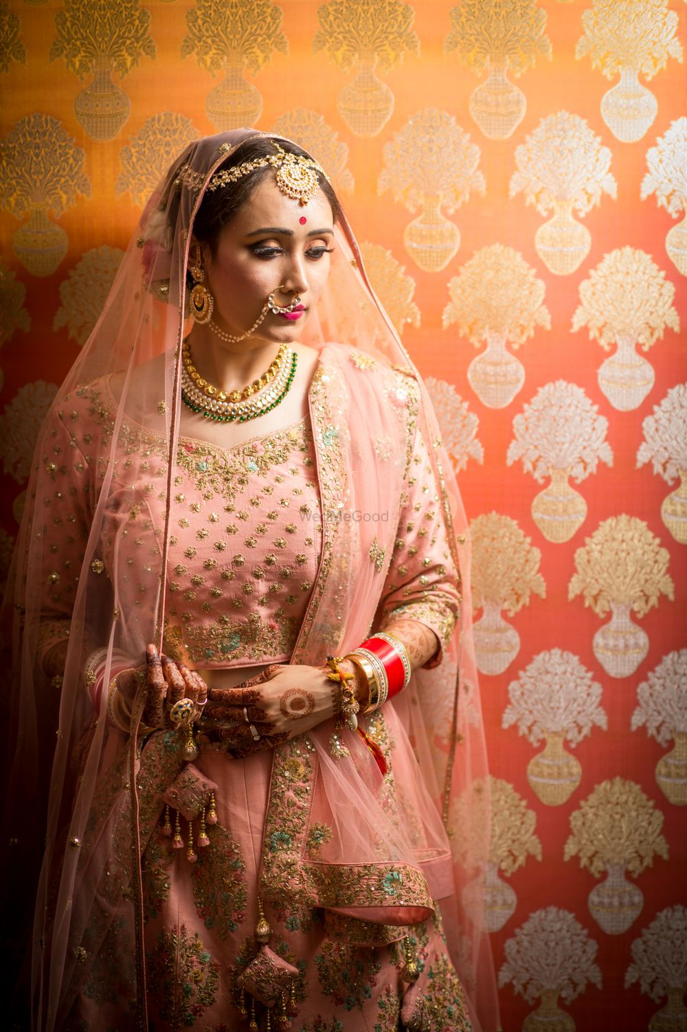 Photo of A bride in light pink lehenga