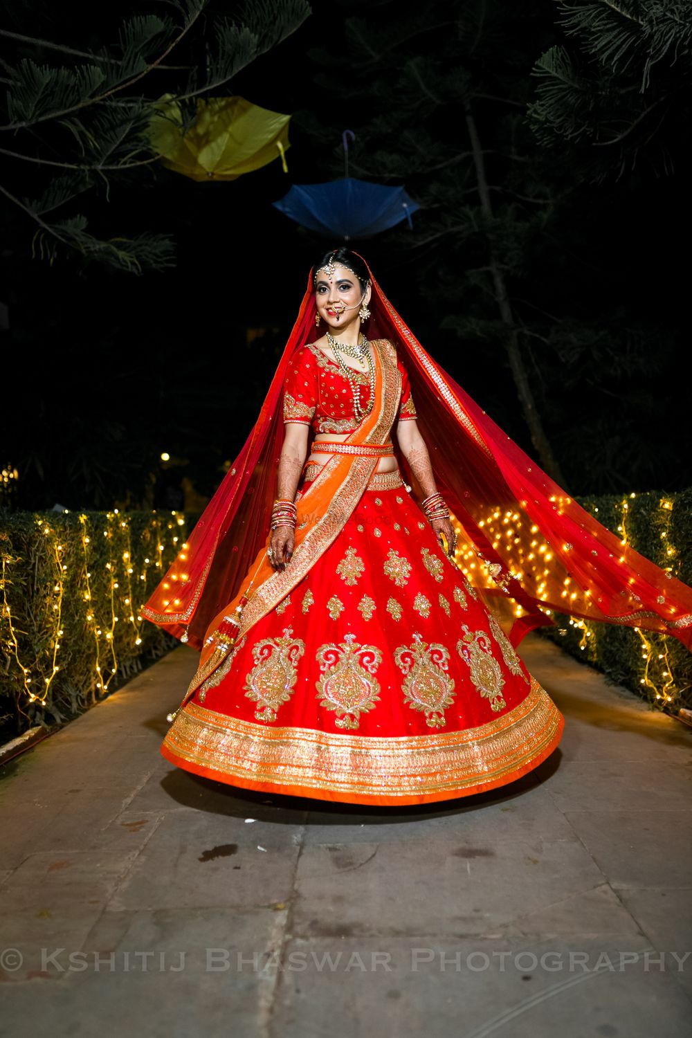 Photo of Orange and red bridal lehenga with waist belt and butis