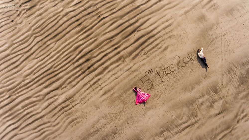 Photo of Save the date idea on sand with drone photography