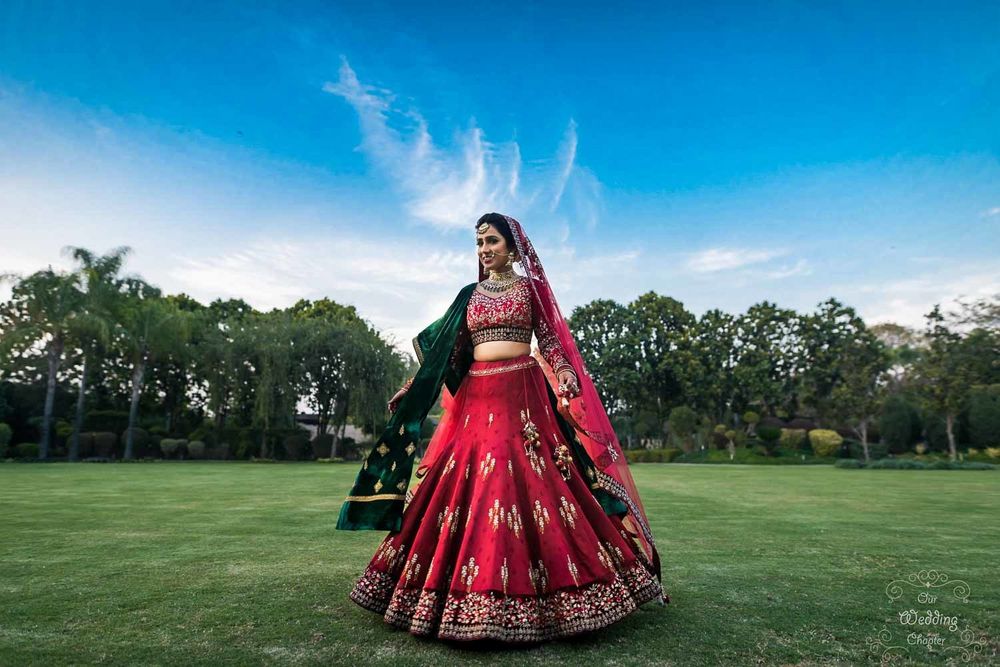 Photo of Bride twirling in red lehenga