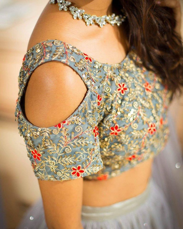 Photo of Pale blue cold shoulder blouse with red embellishment