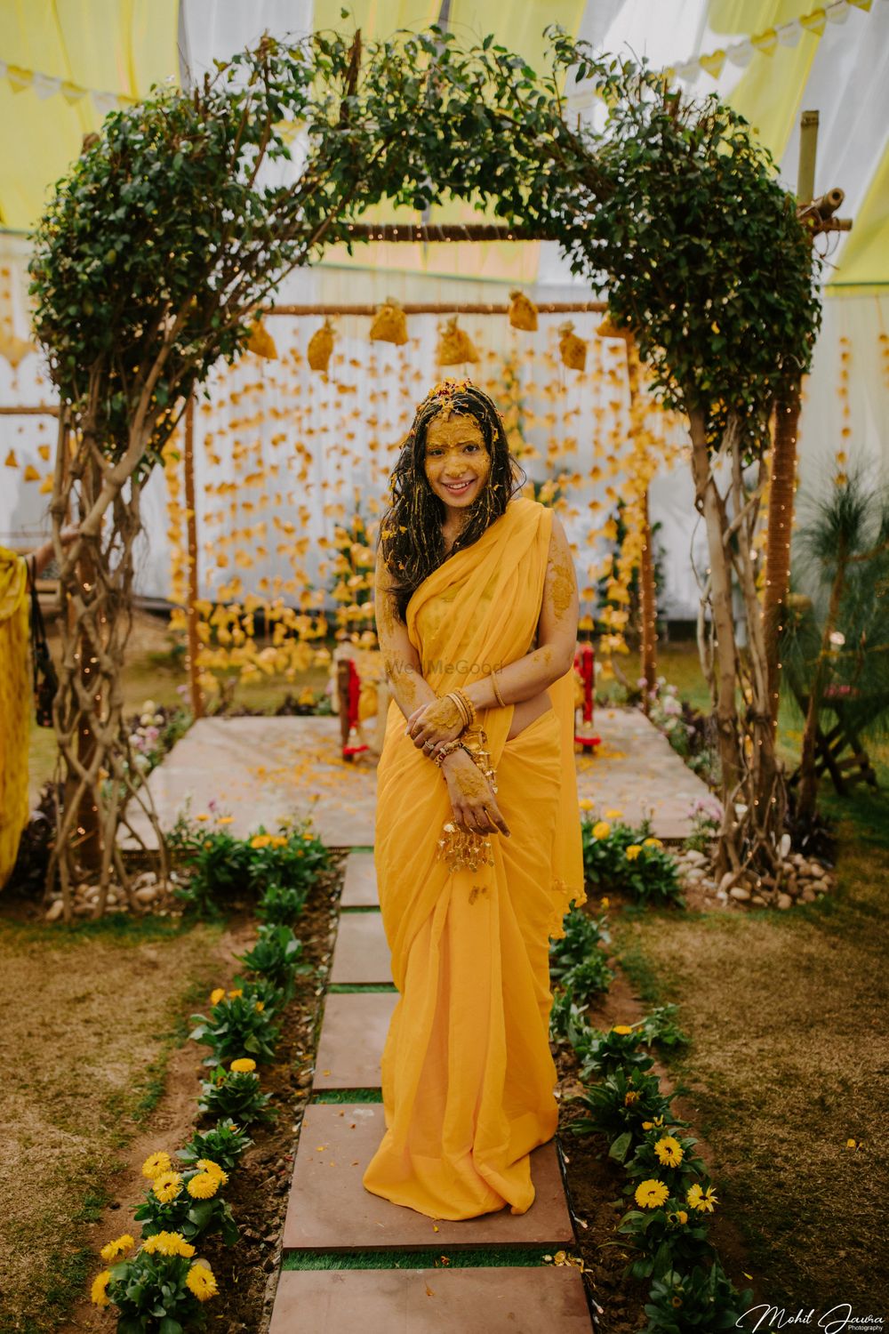 Photo of A minimal Haldi backdrop with bride in yellow saree!