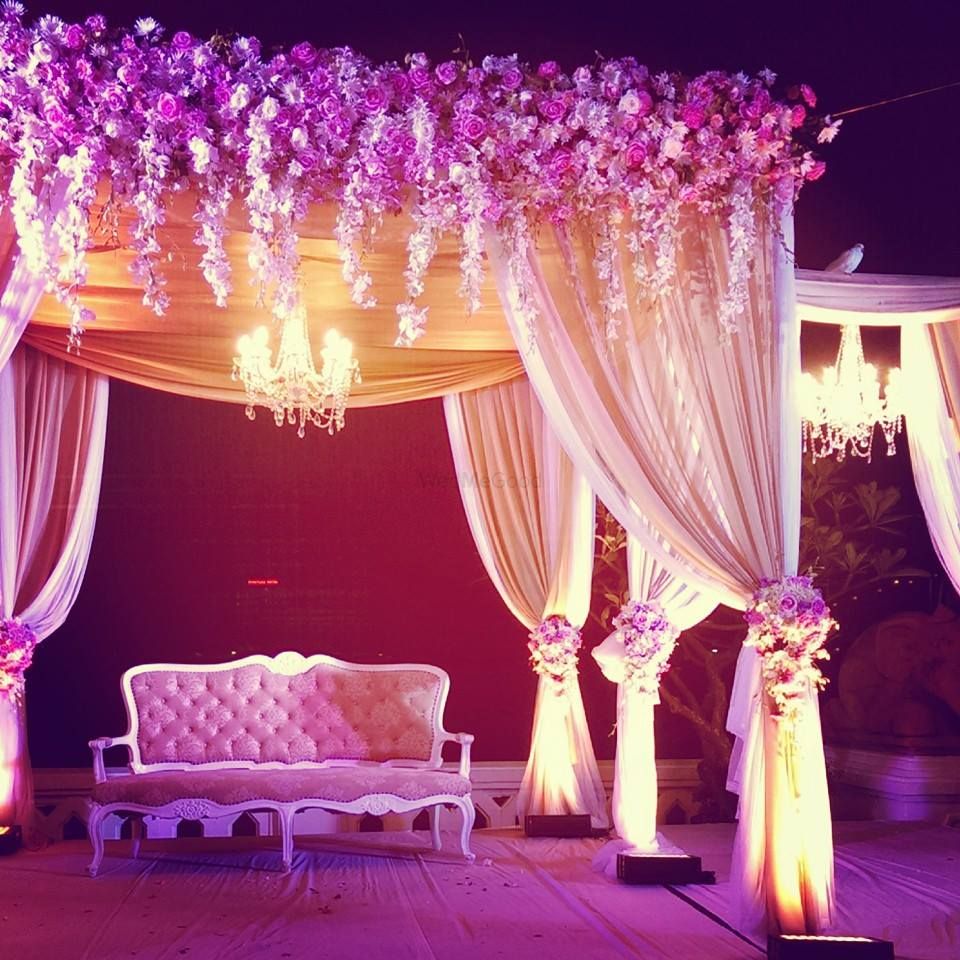 Photo of Light pink floral mandap woth curtains