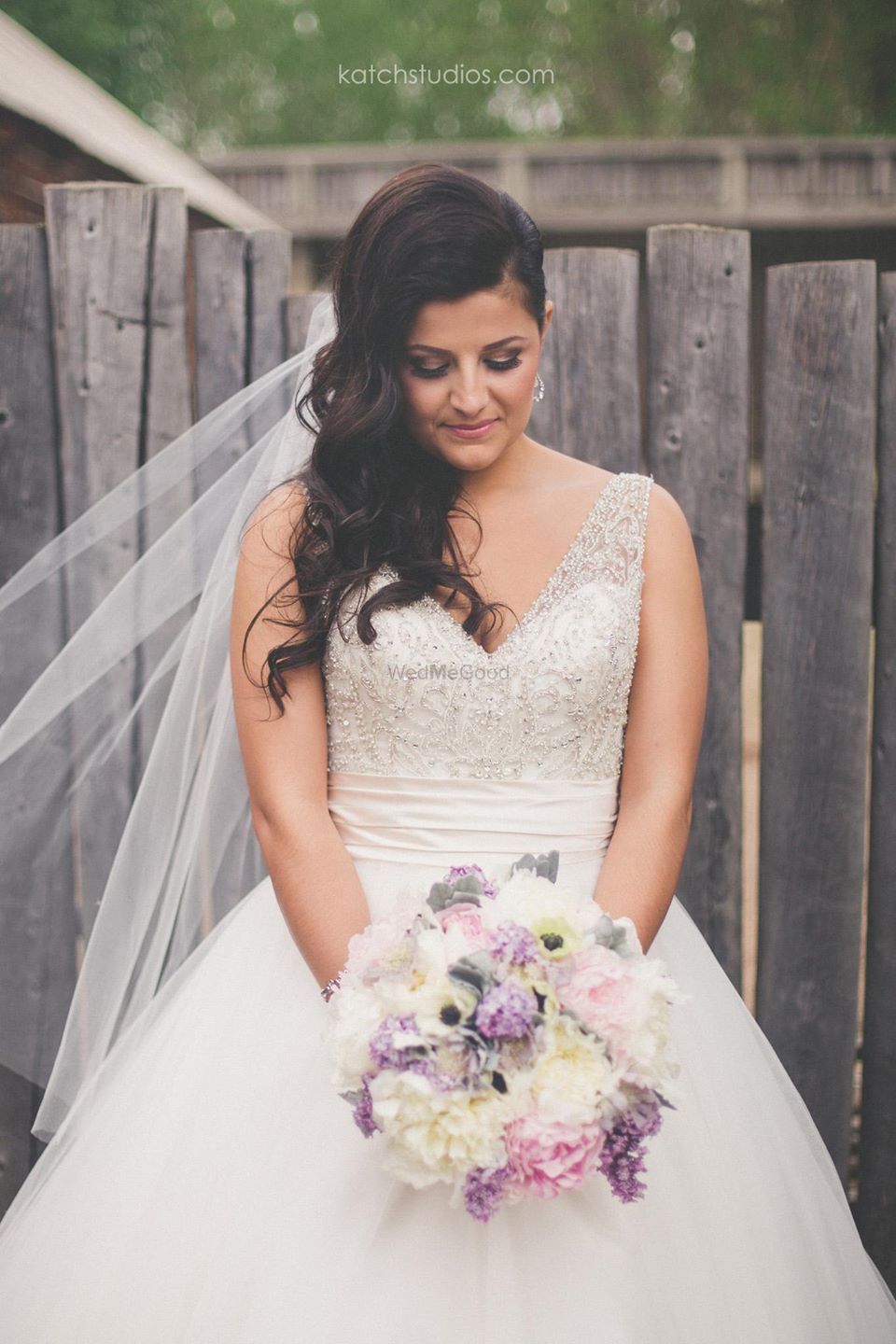 Photo of Grey and white wedding gown with lavender bouquet
