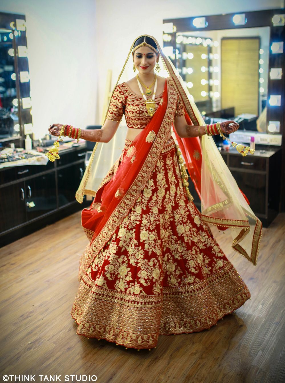 Photo of Red bridal lehenga with bright gold floral print