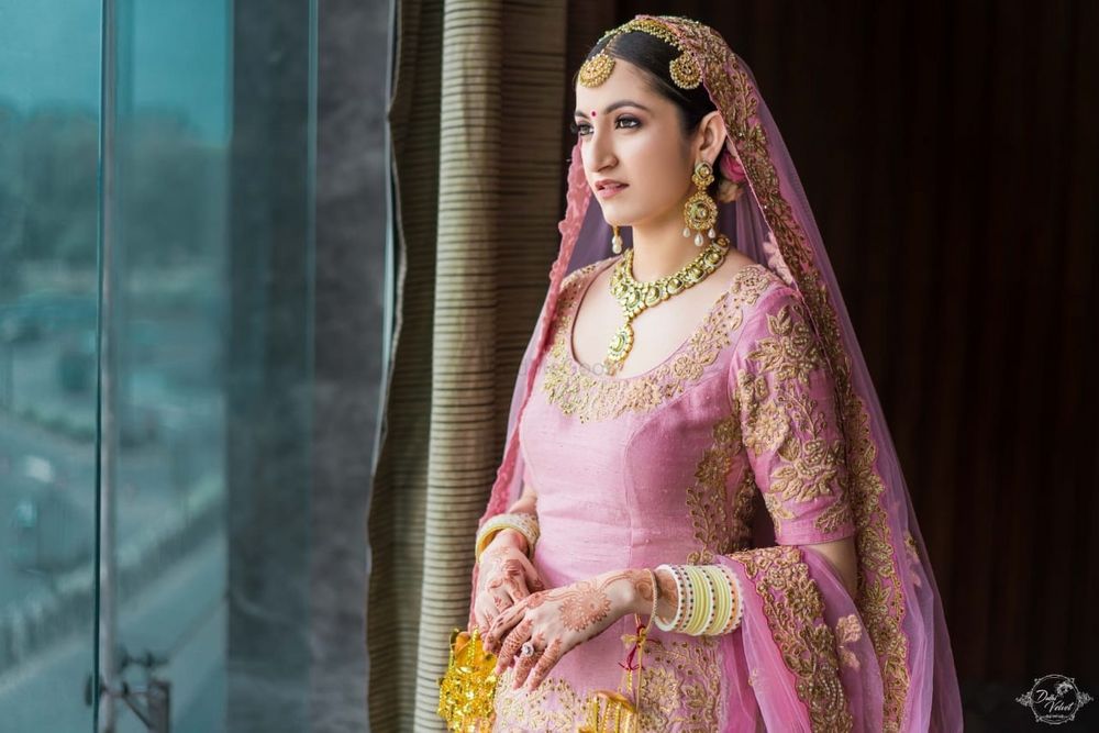 Photo of Bride in light pink Anarkali and yellow Chura