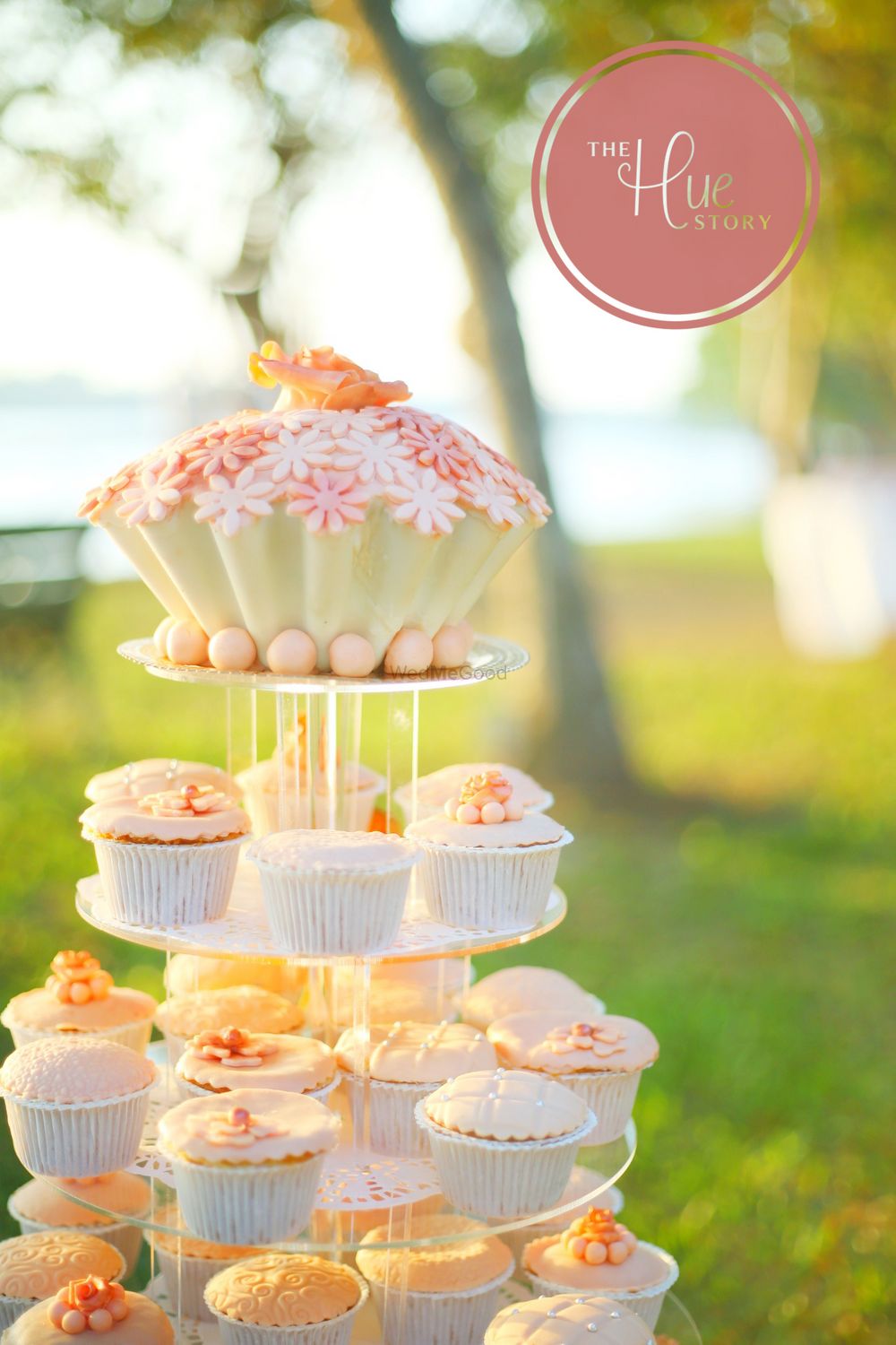 Photo of Orange and white theme cupcakes on stand as wedding cake