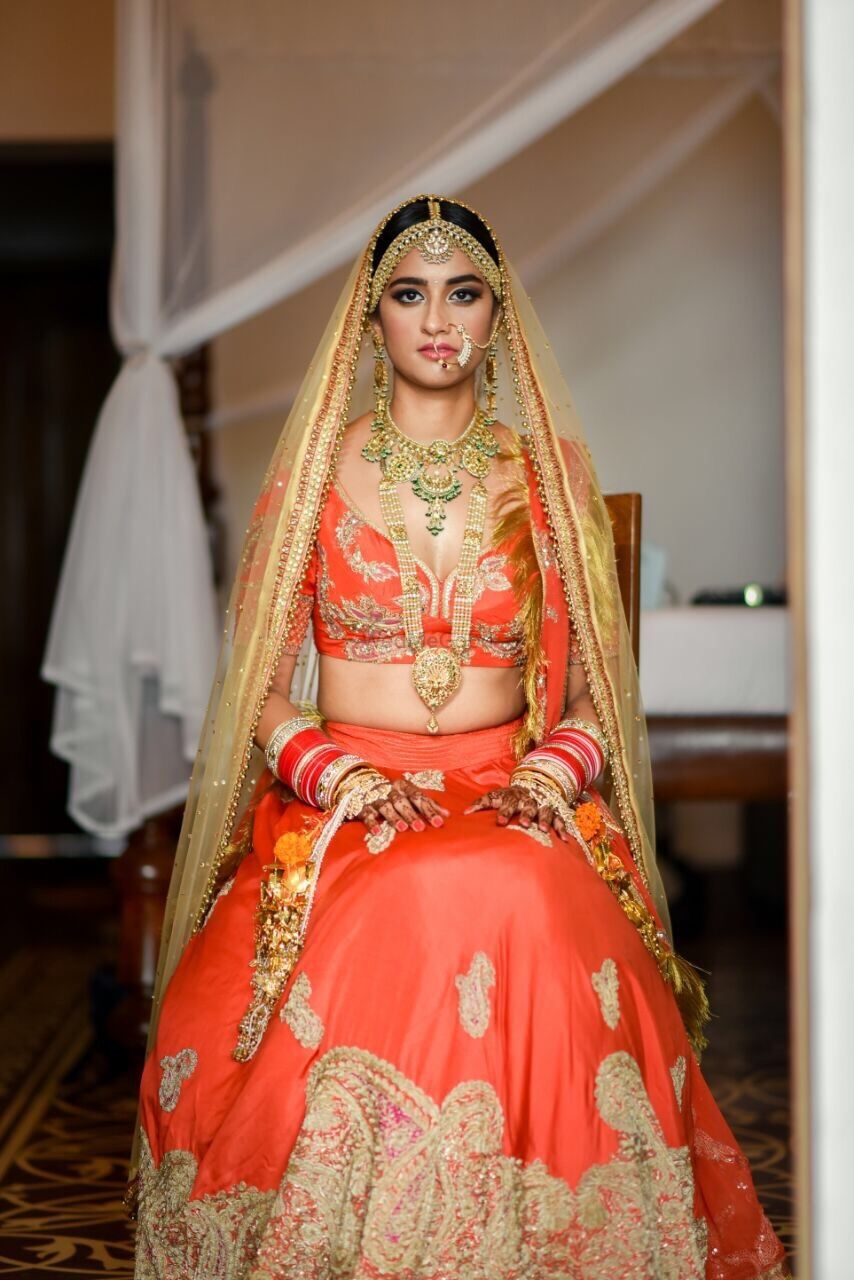 Photo of Bright orange and gold bridal lehenga
