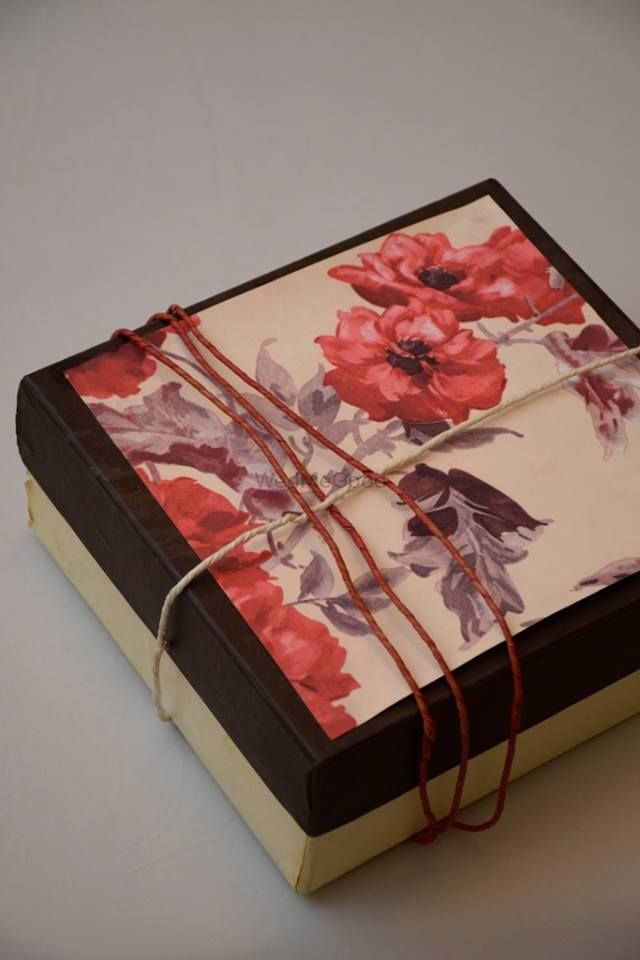 Photo of rustic wooden invitation box with floral print watercolor invite