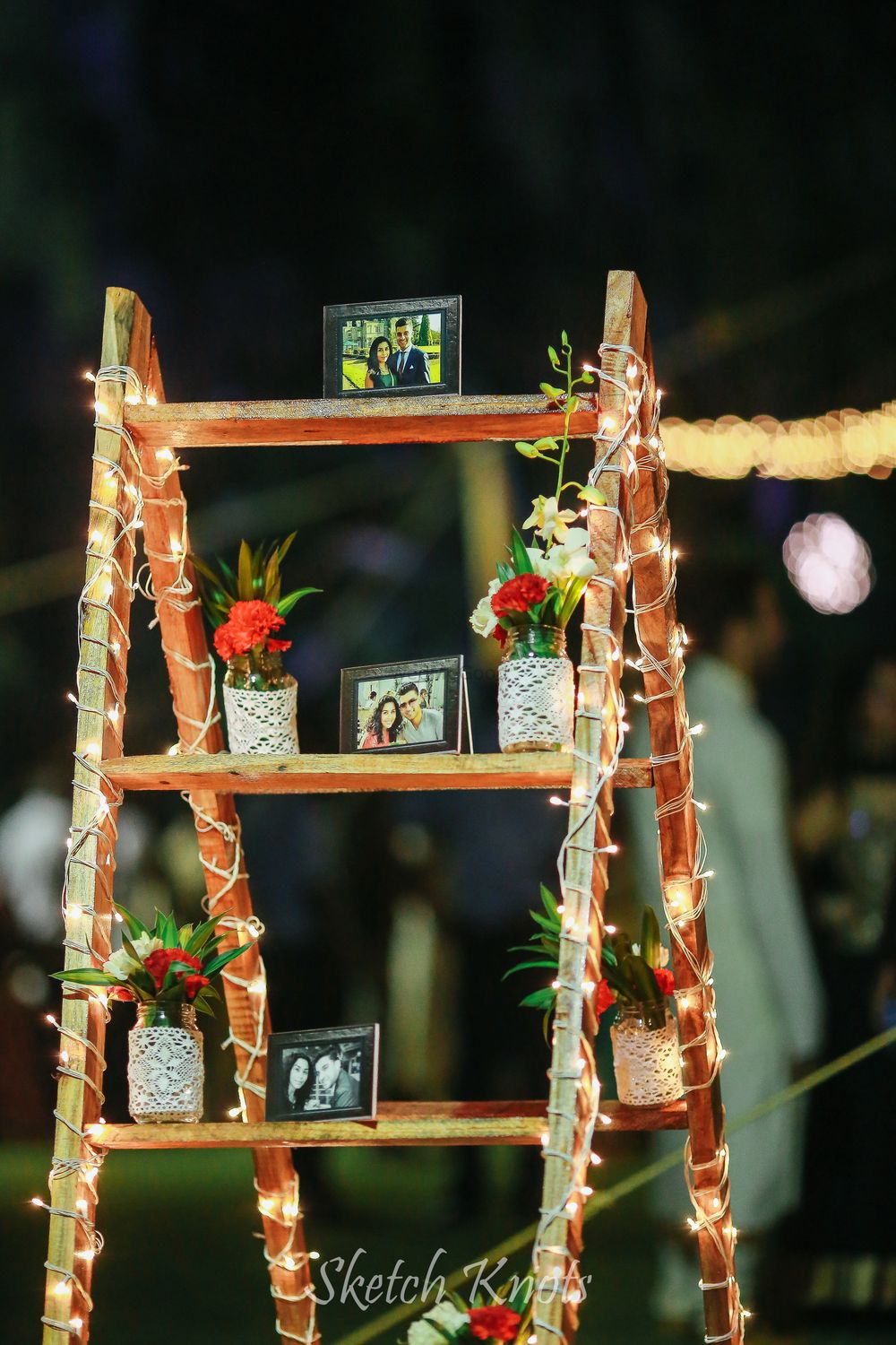Photo of Wooden ladder in decor with lights and personalized elements