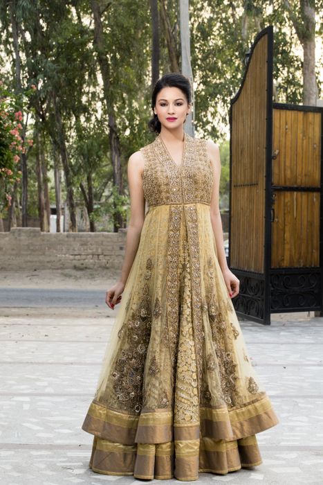 Photo of gold layered anarkali jacket lehenga in sleeveless net