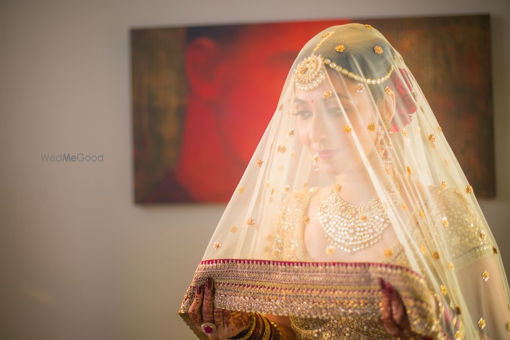 Photo of Bridal portrait with gold dupatta on the face