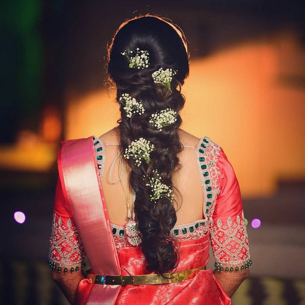 Photo of South Indian bridal braid pinned with baby's breaths
