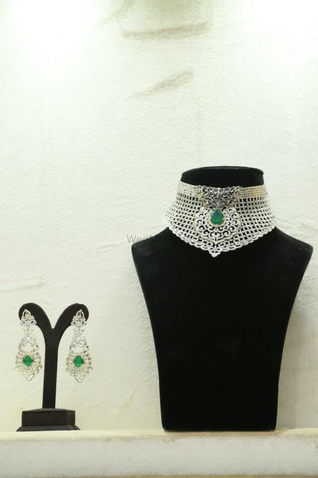 Photo of Diamond choker engagement collar with emerald centerpiece