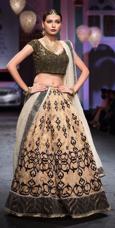 Photo of Gold lehenga with black embroidery and  short sleeved blouse
