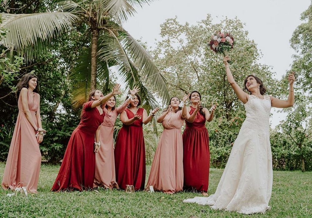 Photo of Bridesmaids catching the tossed bridal bouquet.