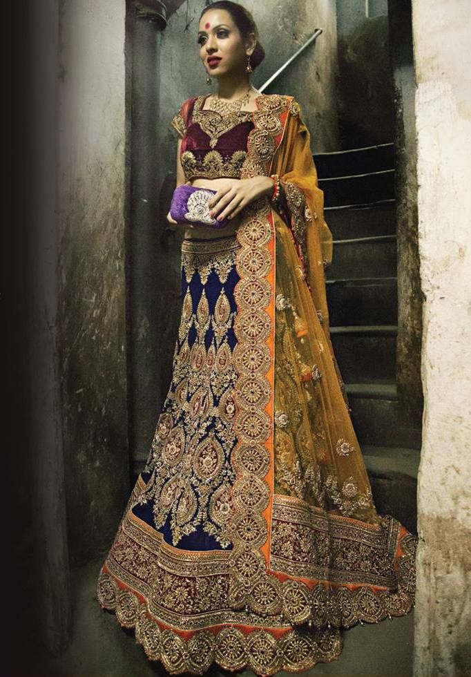 Photo of navy blue velvet royal lehenga with red maroon blouse and yellow dupatta