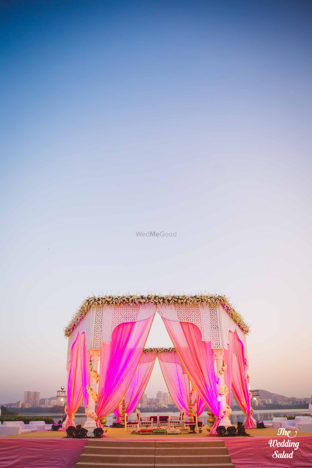 Photo of Bright Pink Outdoor Mandap with Floral Arrangement