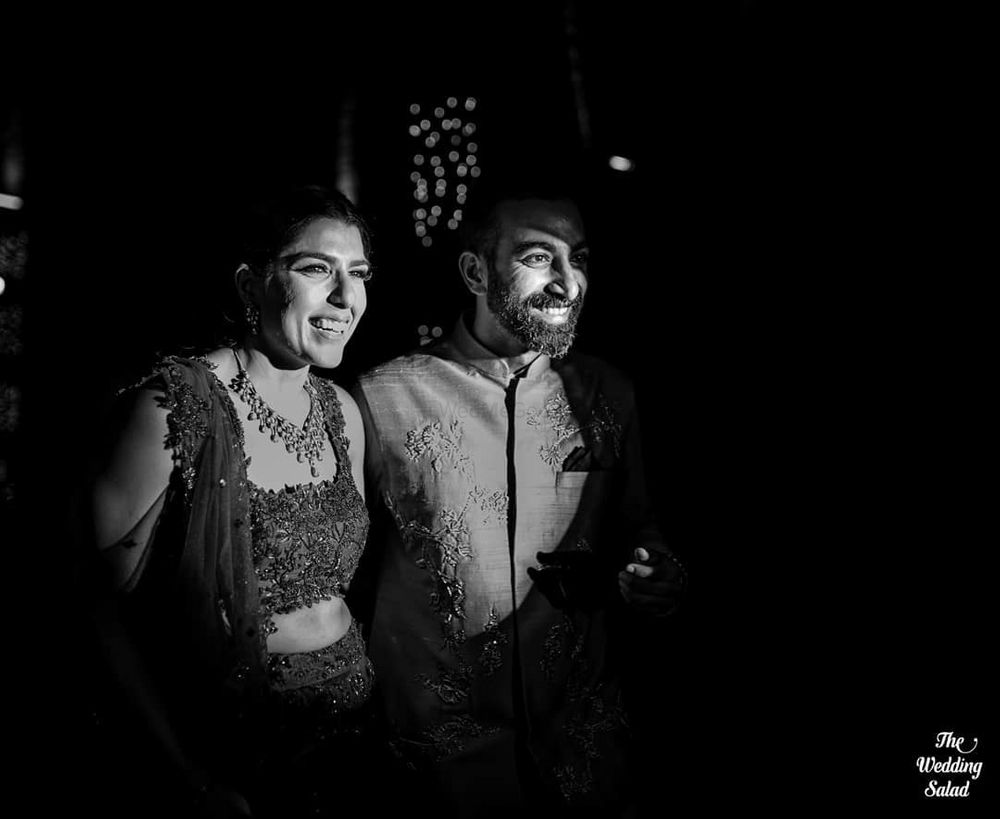 Photo of black and white couple reception shot with limelight on them
