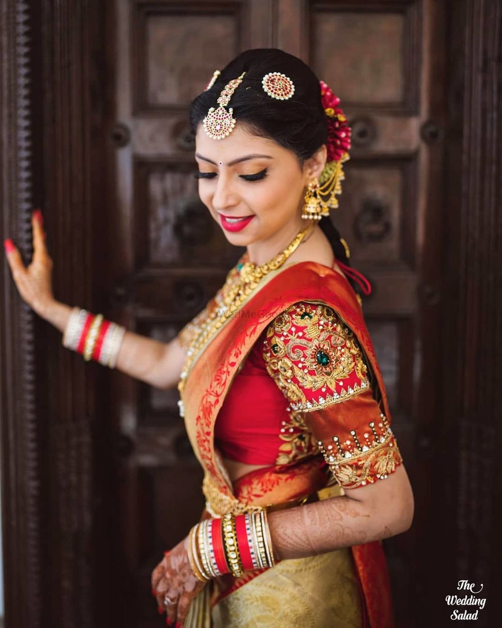 Photo of south indian bridal portrait wearing embroidered blouse in red