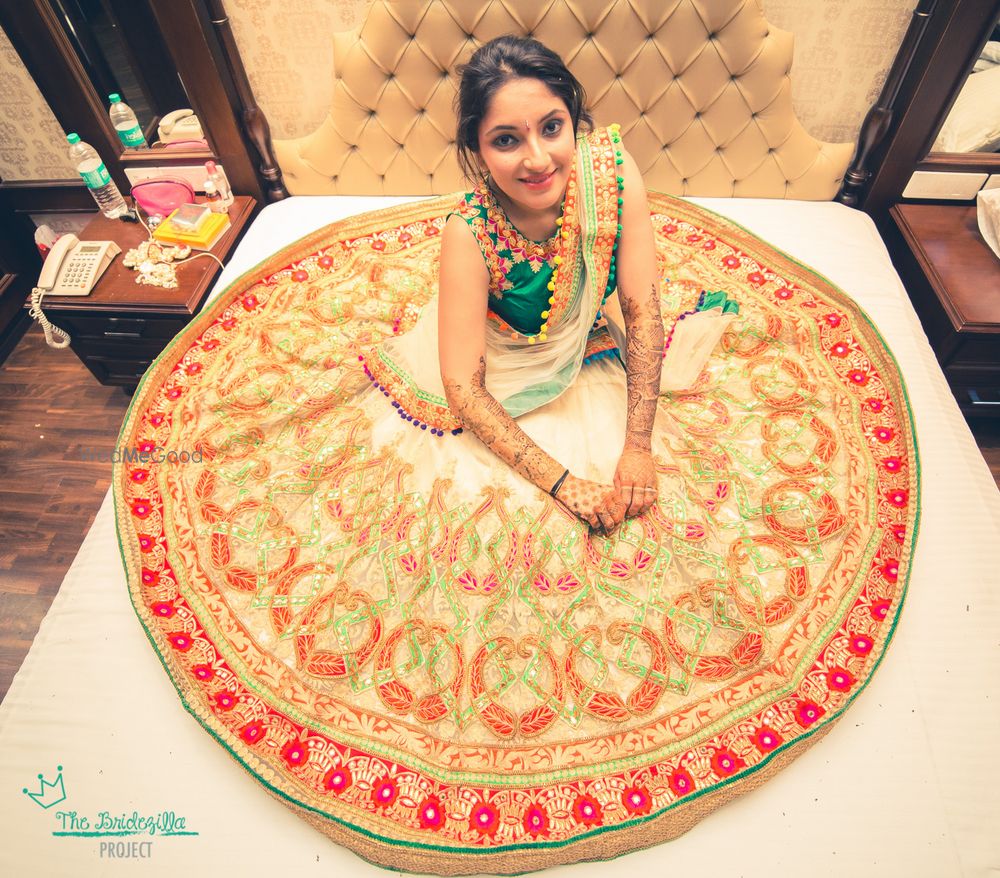 Photo of bride sitting on bed