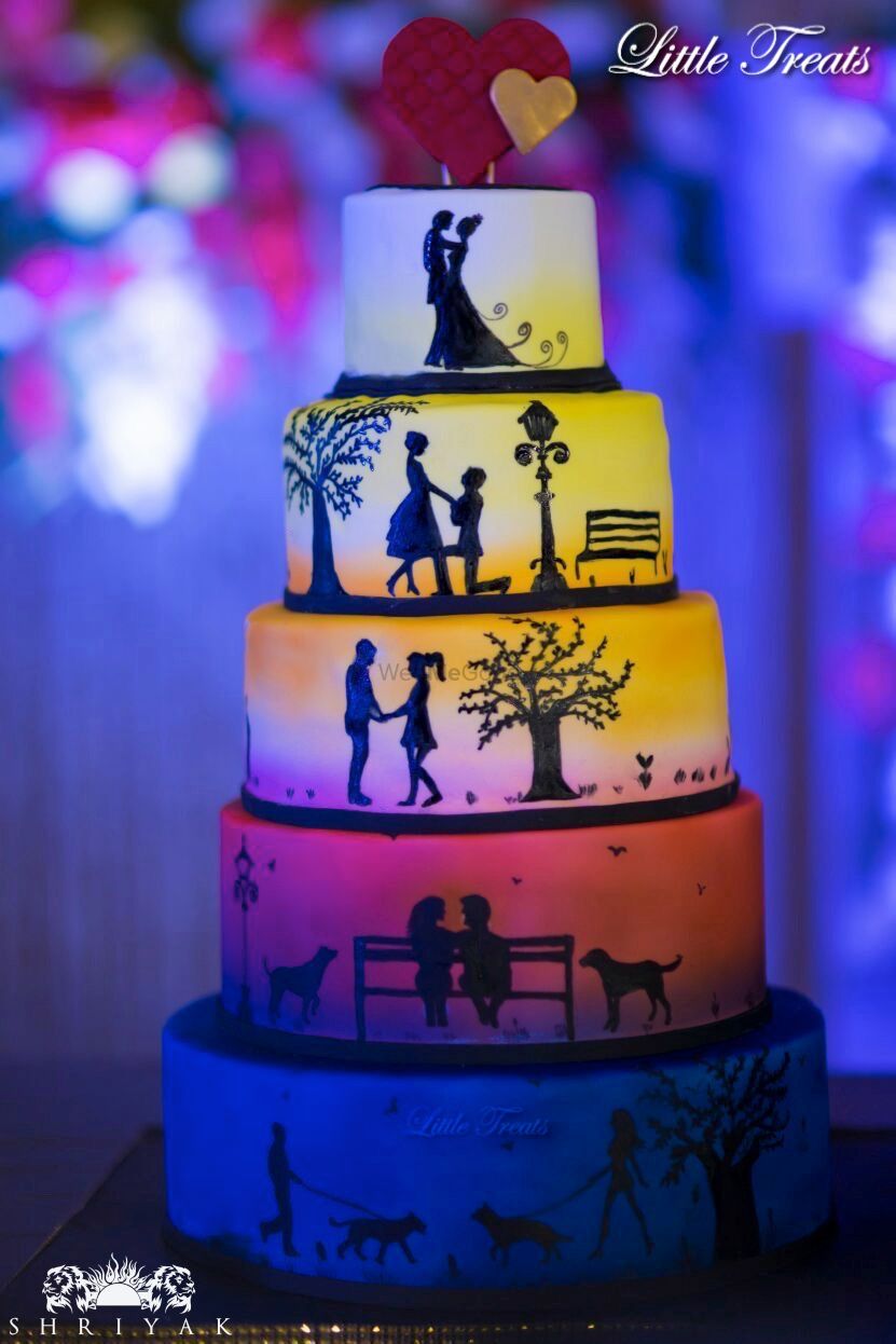 Photo of 5 tiered multicolour cake with couple portraits