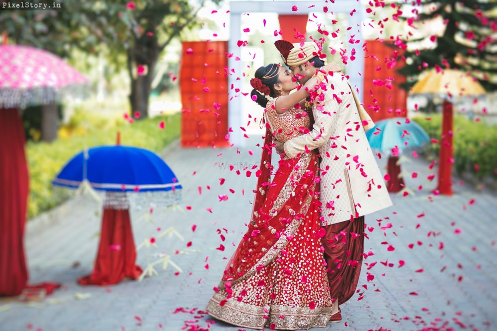 Photo of Couple Kissing Shot with Rose Petals