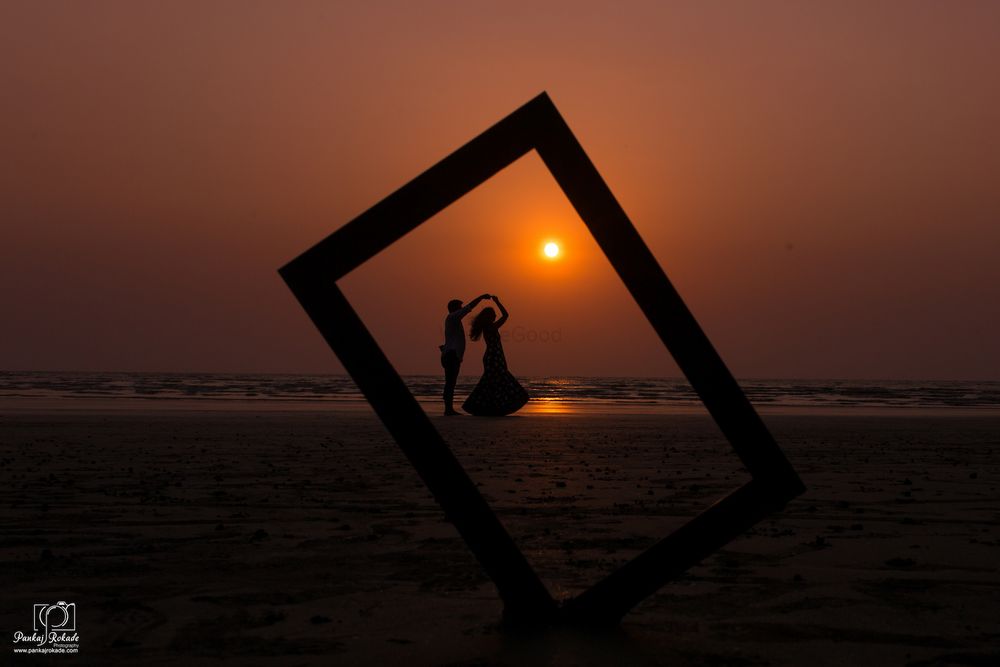 Photo of Sunset pre wedding shoot with prop and dancing pose