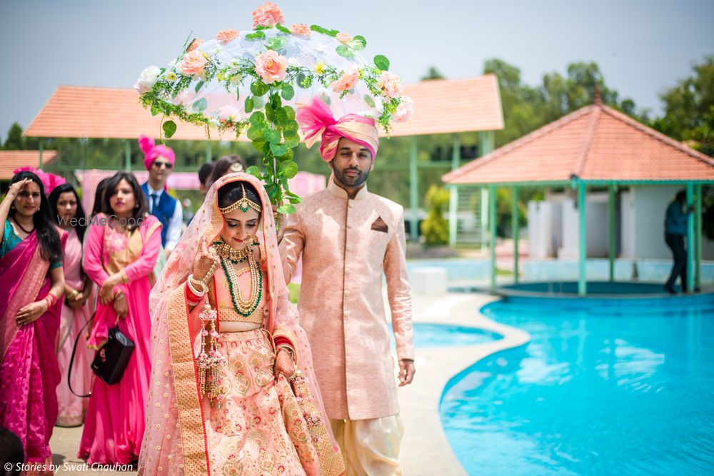 Photo of Bridal entry with brother holding floral umbrella