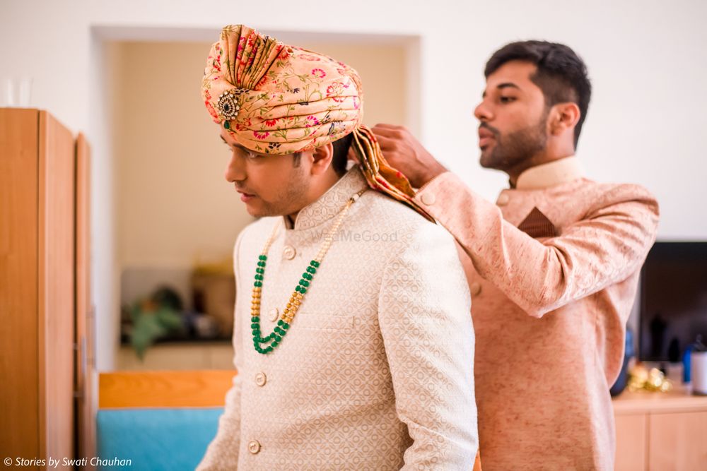 Photo of Groom wearing floral safa with brother