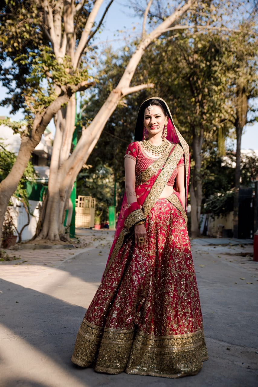 Photo of Bride Wearing Red and Gold Lehenga