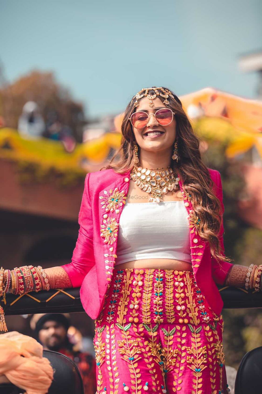 Photo of funky mehendi outfit in bright pink with applique work