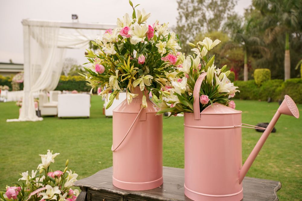 Photo of Pink Water Sprinklers and Floral Decor
