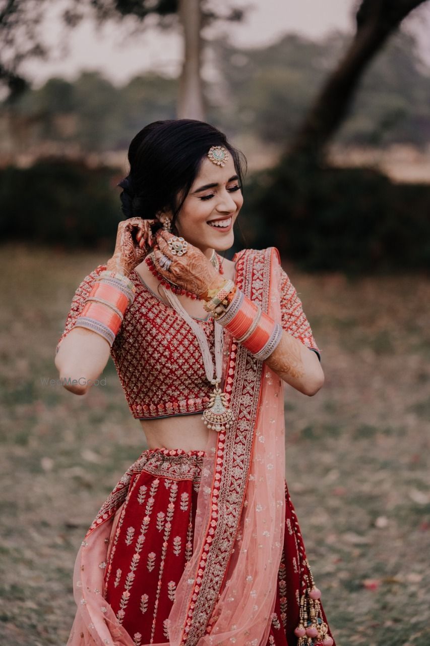 Photo of Candid shot of a bride adjusting her earring.