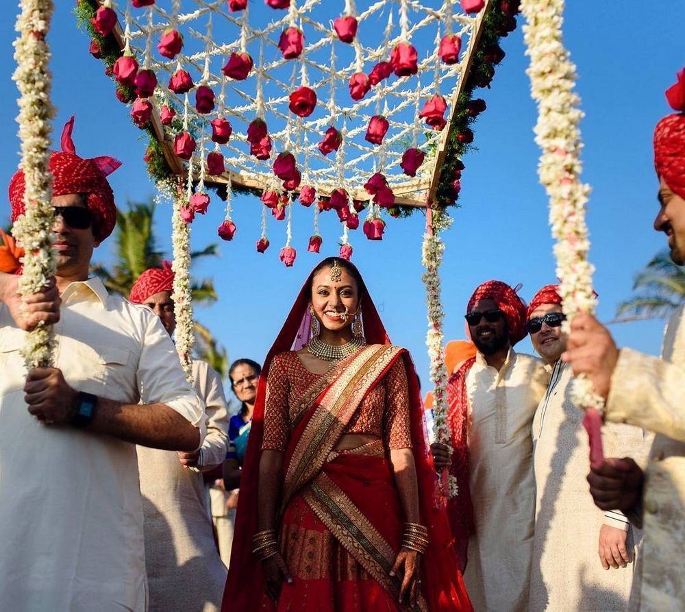 Photo of bride entering under phoolon ki chadar