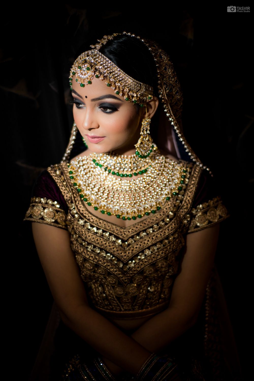 Photo of Gorgeous maroon lehenga for wedding with dazzling kundan and green beads jewellery