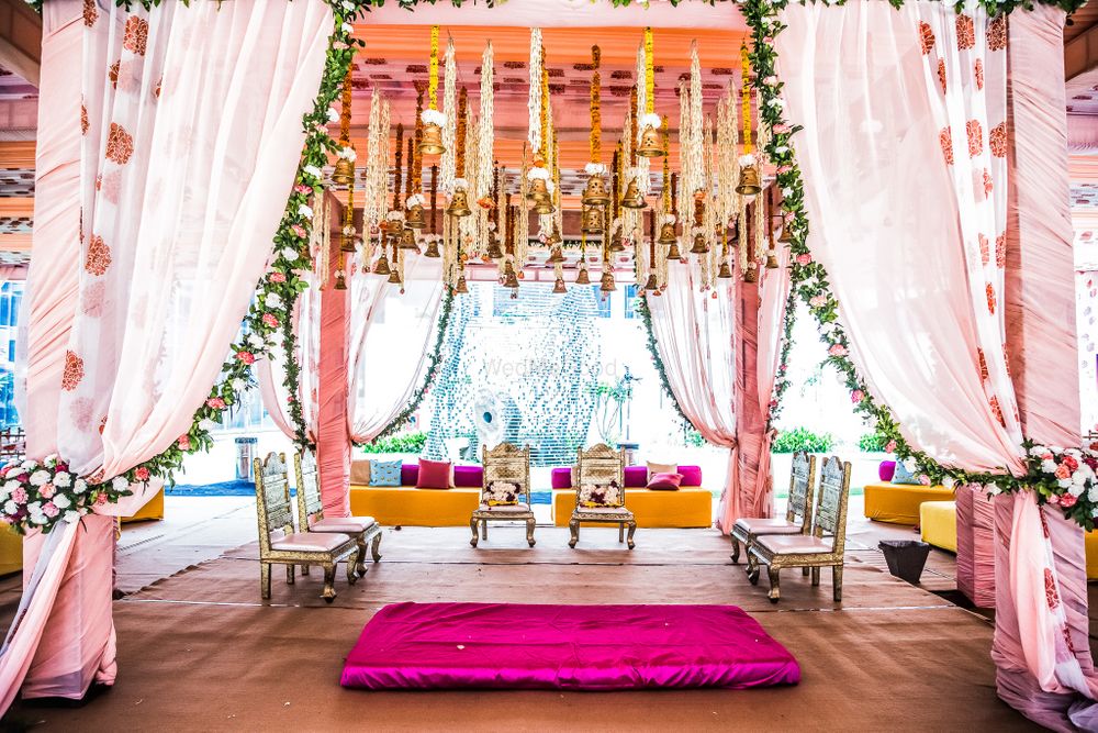 Photo of Mandap in pink with floral printed drapes