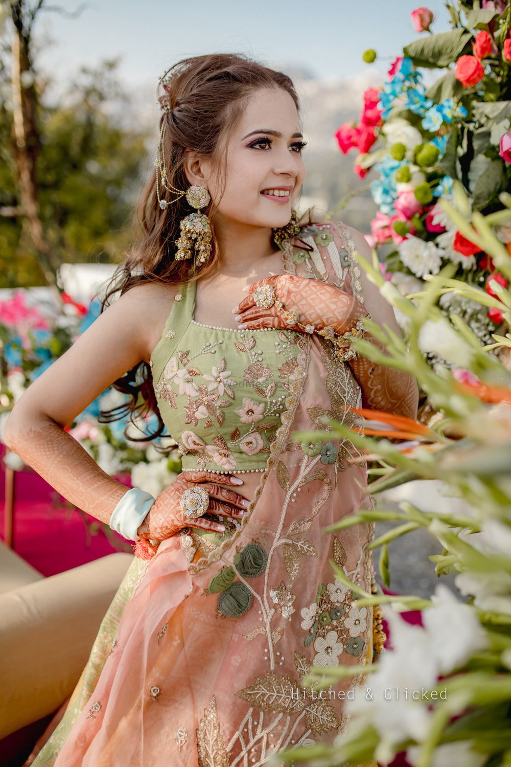Photo of mehendi bridal look with light green and peach lehenga