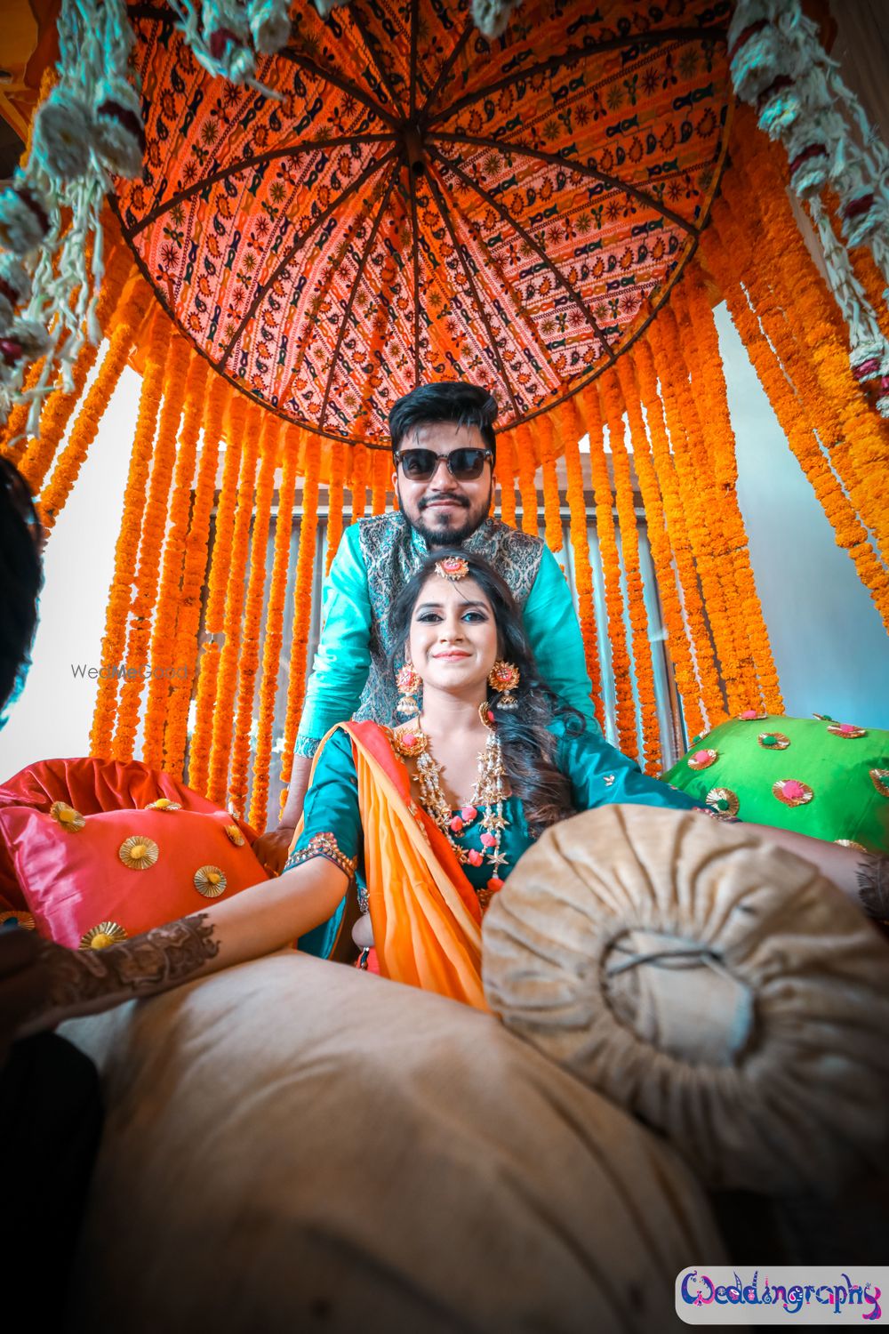 Photo of Mehendi decor with orange and teal theme