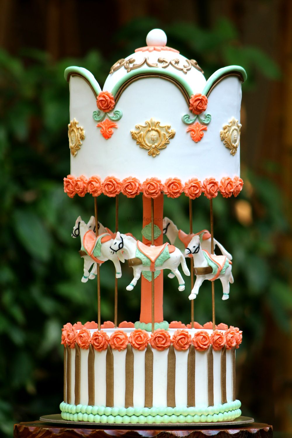 Photo of White and Gold Two Layer Cake with Horse Swings