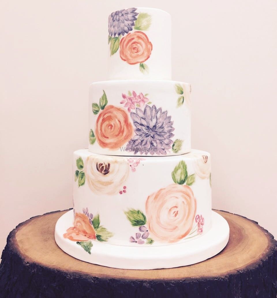 Photo of 3 tier floral print wedding cake with pastel flowers