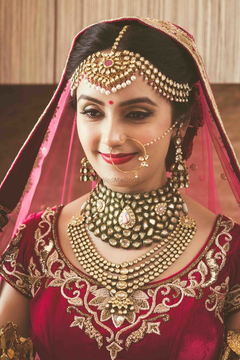Photo of Bride wearing heavy mathapatti and necklaces