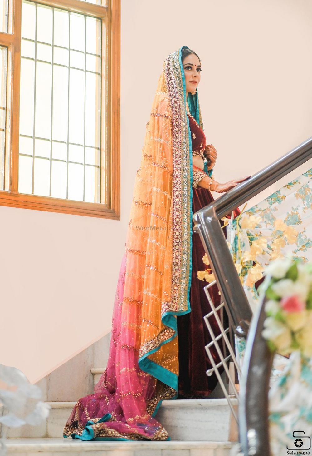 Photo of Sikh bride wearing maroon lehenga with an ombre dupatta.