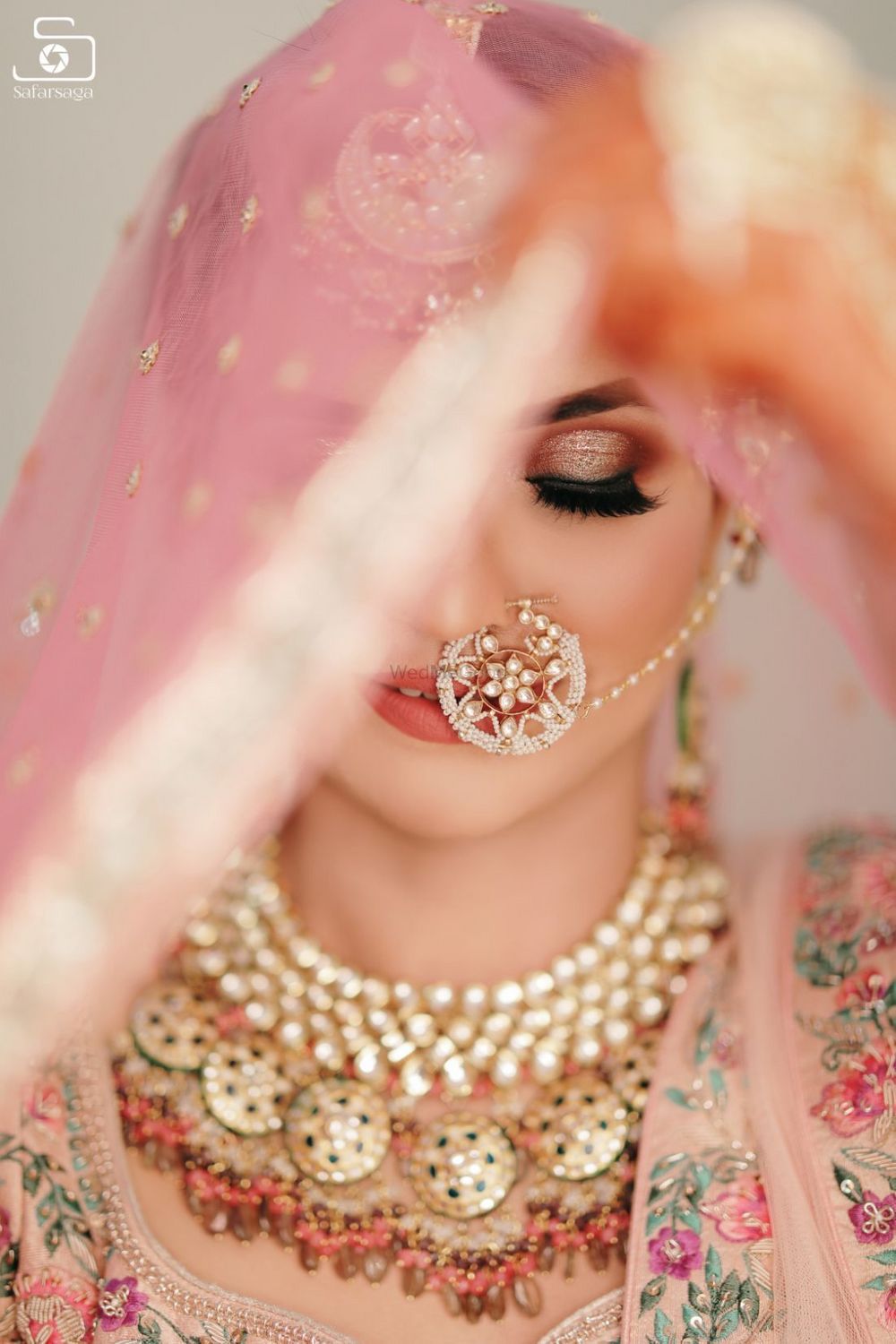 Photo of bridal portrait with pretty nath and pink smokey eye