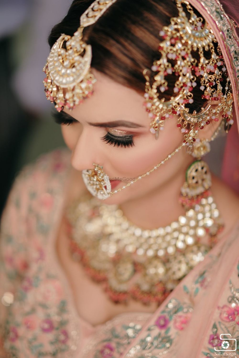 Photo of pretty bridal jewellery with pink beads and oversized jhoomar