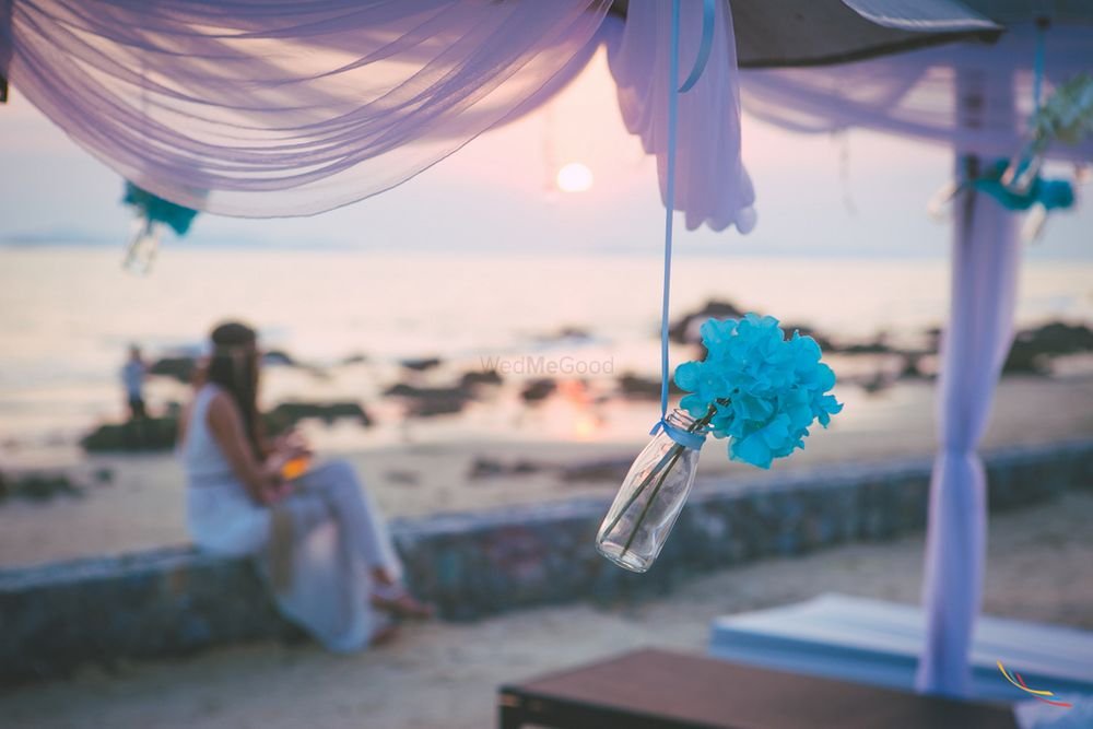 Photo of Beach Wedding Decor with Hanging Bottle and Flowers