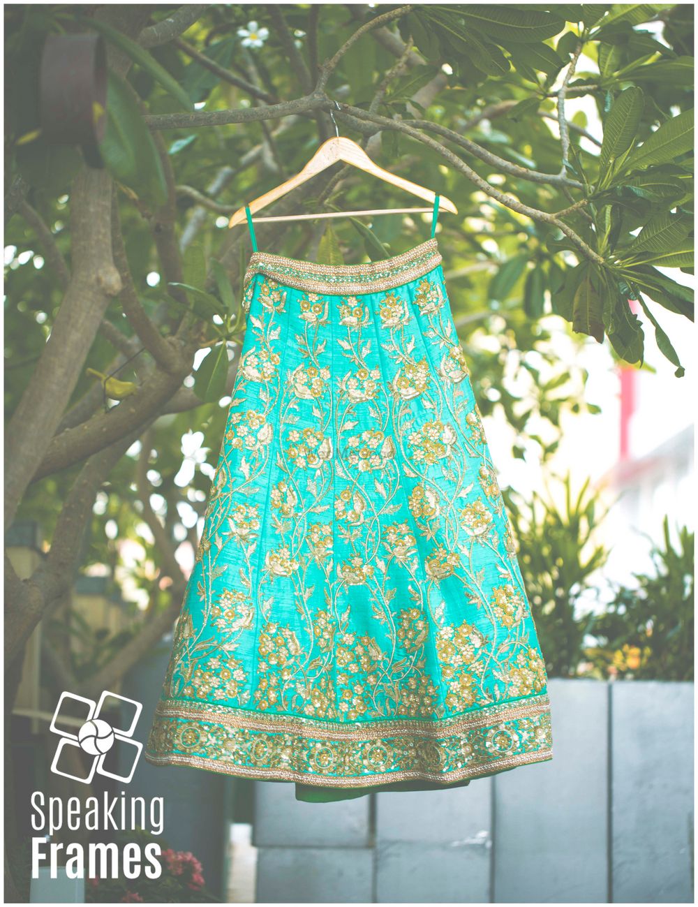 Photo of Aqua Lehenga with Green and Gold Motifs and Pink Border